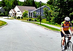 senior riding bicycle in retirement community