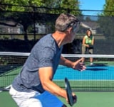 senior couple playing pickleball