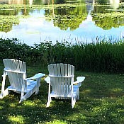 Adirondack chairs next to Maine lake