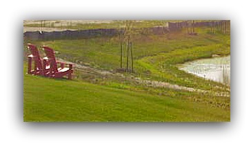 red lounge chairs and pond