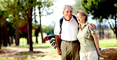 senior couple golfing