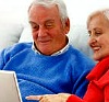 senior couple with laptop 100